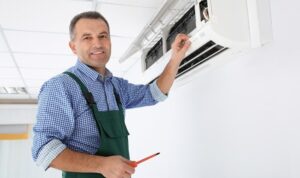 Young Repairman Repairing Ceiling Air Conditioning Unit Stock Photo ...