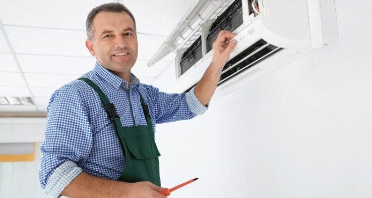Young Repairman Repairing Ceiling Air Conditioning Unit Stock Photo ...